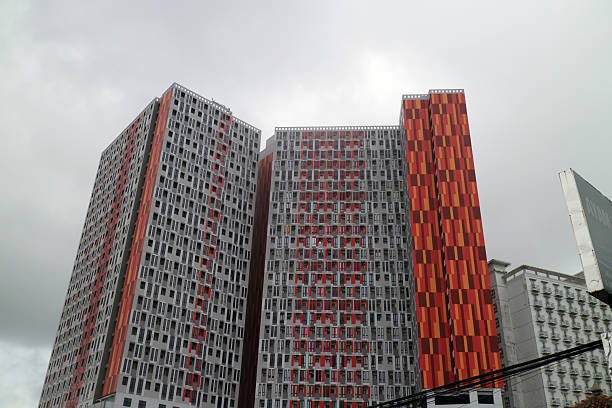istock Colorful High Rise Buildings Against Cloudy Sky 2231149325