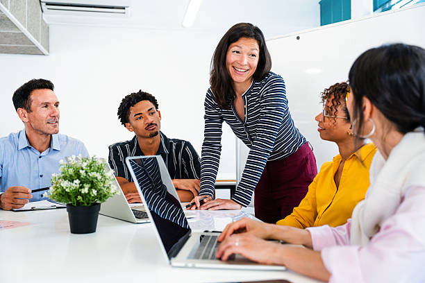 istock Business people collaborating on project in startup office meeting 2231149604