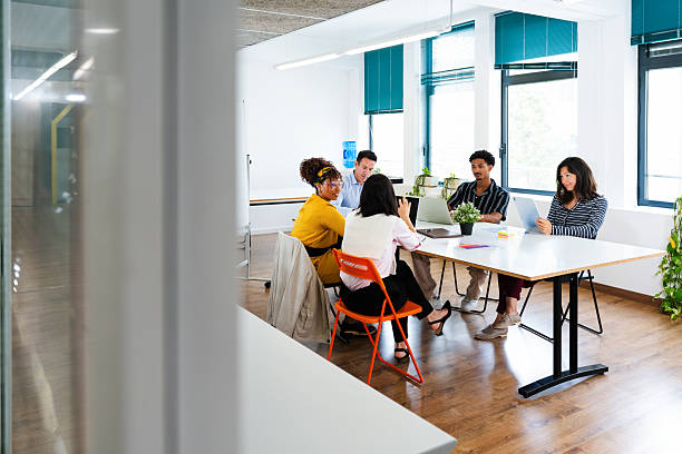istock Business people collaborating on project in modern office startup environment 2231149683
