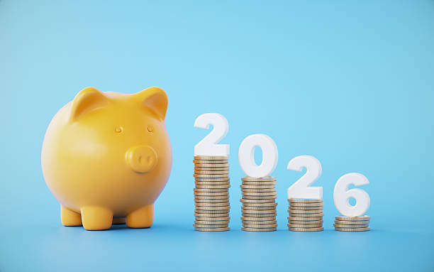 istock Orange Color Ceramic Piggy bank and Coin Stack with White 2026 text on blue background 2231150827