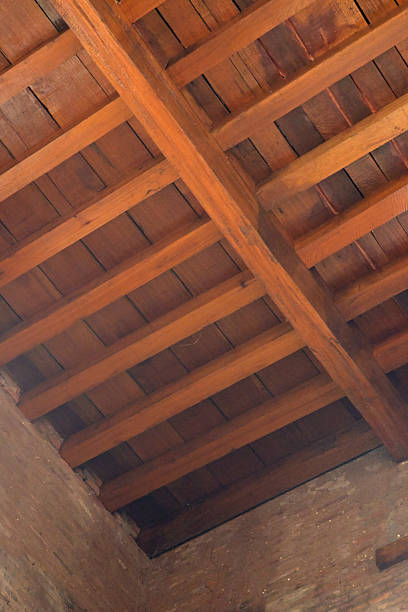 istock Wooden ceiling with exposed beams arranged in a geometric pattern. 2231151460