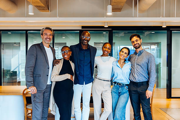 istock Group of cheerful professionals posing confidently in a contemporary office environment 2231160409