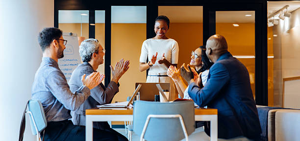 istock Diverse team applauding a young speaker during a meeting in a bright office 2231160560