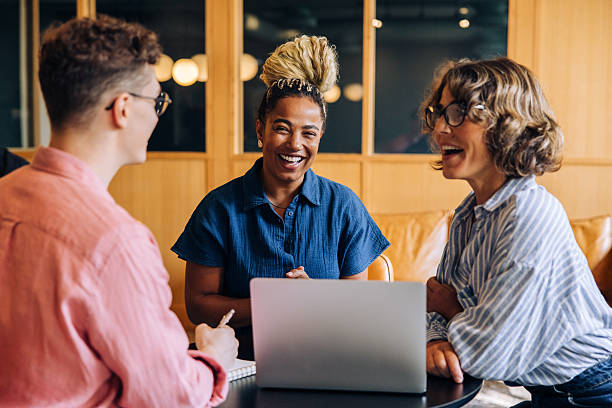 istock Smiling team of three professionals having a collaborative meeting in a modern office 2231160680