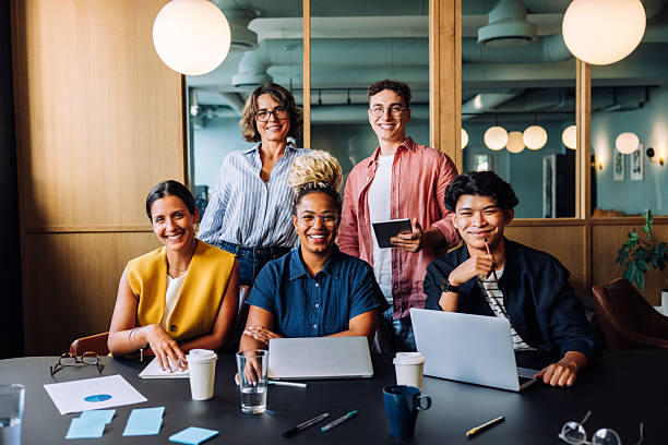 istock Group of colleagues smiling and working together in an office setting 2231160741