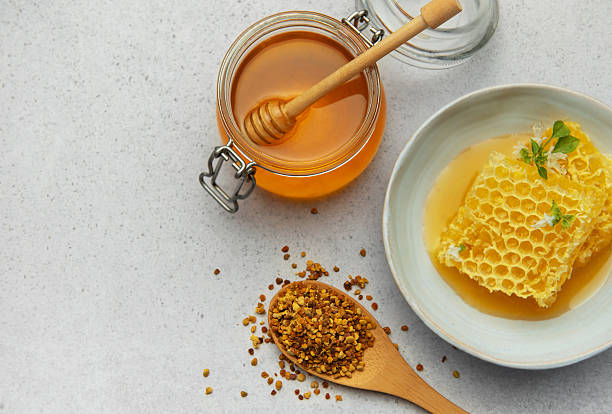 istock Honey, honeycomb and bee pollen creating delicious golden composition 2231161607