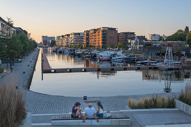 Hasselt, Belgium - 2025, June 30 : The harbour of Hasselt on the Albert Canal with some people enjoying the evening outside