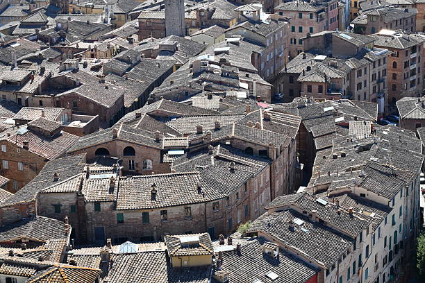 a curvy street in siena in morning light seen from above