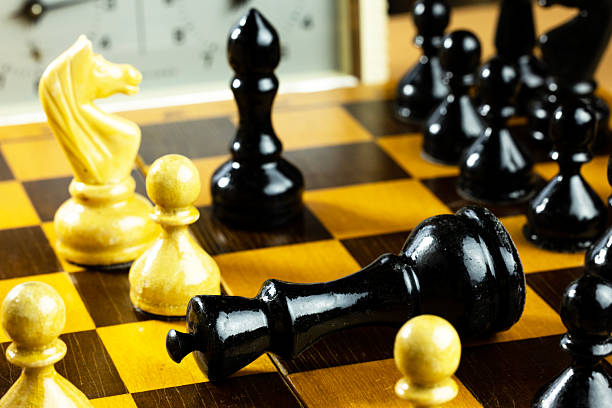 istock A close-up of a chessboard with black and white pieces. 2231165516