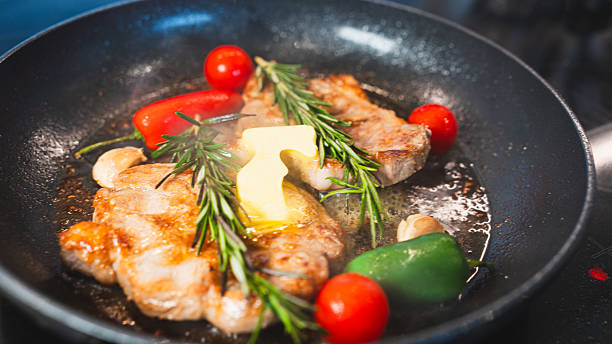 Pork Chops in Pan with Cherry Tomatoes, Peppers, and Rosemary