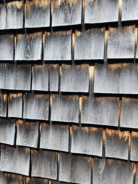Photograph of the weathering pattern of cedar wood house shingles as they age.