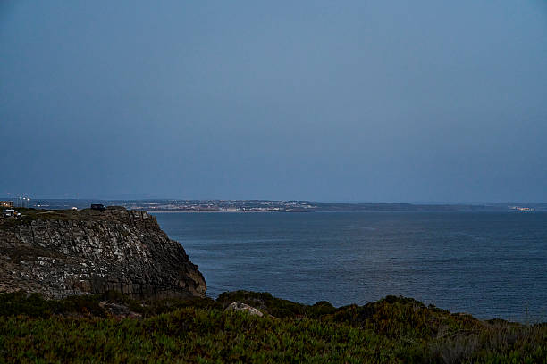 Mature hispanic woman standing on remote coastal headland