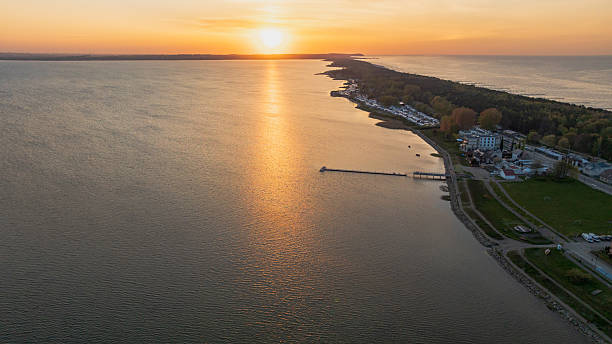 istock Sunset Over a Lake with Pier and Forested Shoreline 2231170968