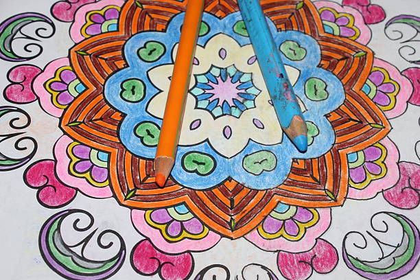 Colored pencil lying on a colored mandala drawing