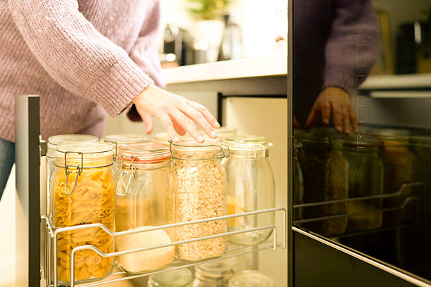 istock Woman taking ingredients from kitchen cupboard for cooking 2231181361