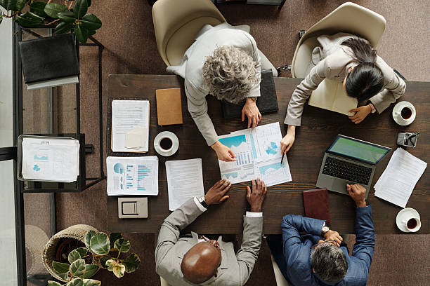 istock Diverse Group of Middle Aged Professionals Analyzing Financial Reports Together 2231181717
