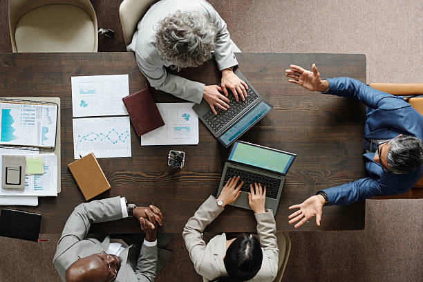 istock Diverse Middle Aged Business Team Collaborating during Office Meeting 2231181752