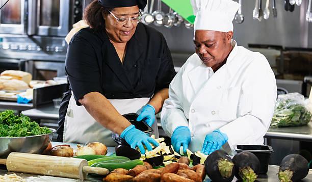 istock Two female cooks in restaurant kitchen prepare vegetables 2231182251