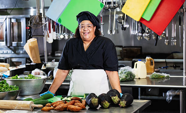 istock Senior black woman working as cook in restaurant kitchen 2231182253