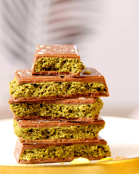 istock Dubai chocolate. Chocolate bars stacked elegantly on a plate, showcasing a rich texture and vibrant green filling, highlighting the delicious fusion of flavors in a gourmet dessert concept 2231183125