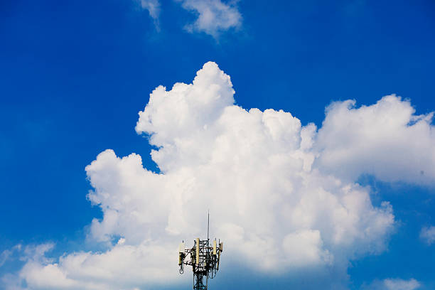 silhouette of three workers repairing communication tower