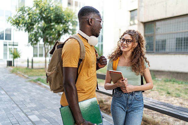 istock Two college students walking and talking on campus 2231184819