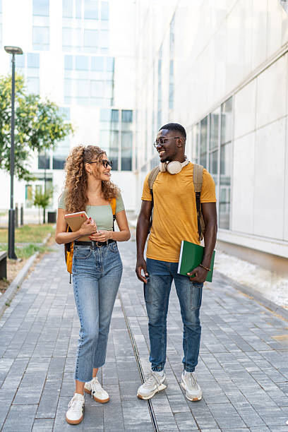 istock Cheerful students walking and talking on university campus 2231184853