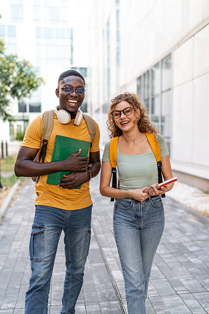 istock Cheerful multi-ethnic students walking and talking together on campus 2231185059
