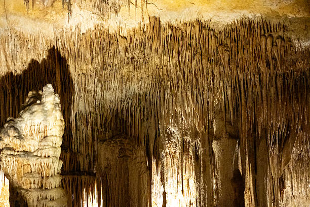 istock Stunning limestone stalactites and stalagmites in illuminated cave interior 2231185272