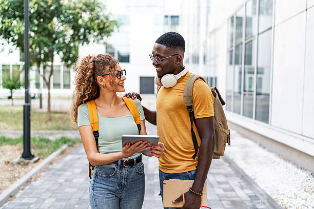istock Cheerful students walking and talking on university campus 2231185335