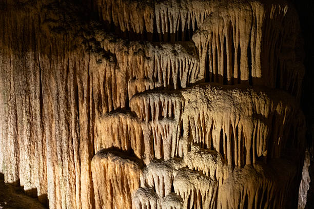 istock Majestic stalactites and stalagmites in dimly lit mysterious cave 2231185364
