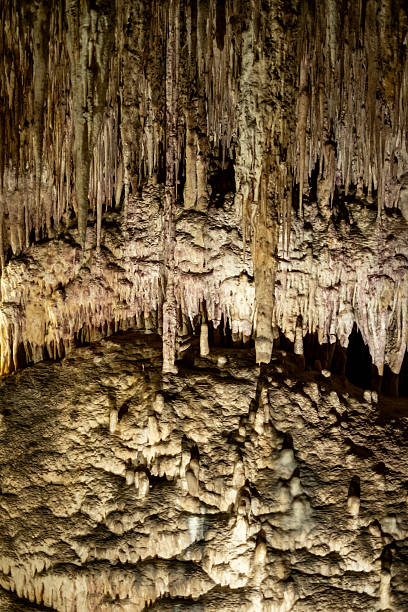 istock Majestic limestone cave interior with stunning stalactites and stalagmites formation 2231185428