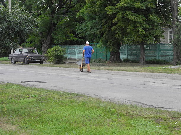 Man working with wheelbarrow in Grod village posluk z objects visible human dorga