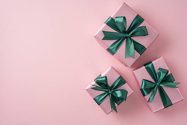 istock Elegant pink presents featuring green bows, displayed on a soft pastel backdrop. Perfect for holiday, celebration, and gift themes 2231193379