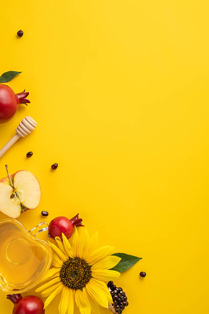 istock Vibrant vertical composition featuring Rosh Hashanah themes like honey, apple, and pomegranate on a colorful background 2231193407