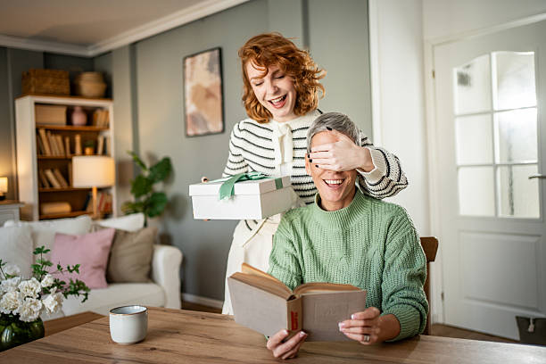 istock Daughter surprising mother with a gift at home 2231193518