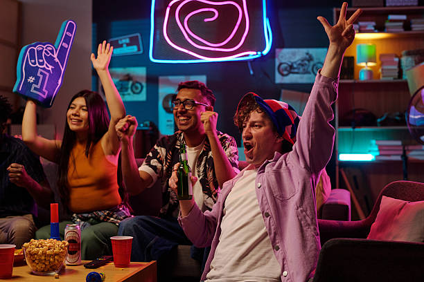 istock Diverse Young Adults Celebrating Victory While Watching Sports Game Indoors 2231193603