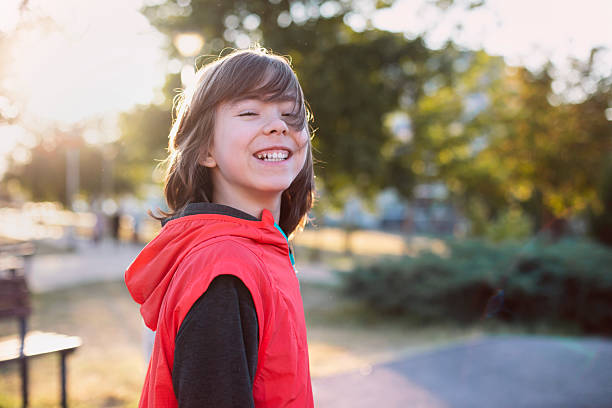 Portrait of cheerful boy in sportswear outdoors. Healthy and active lifestyle, kids happiness, playful and carefree childhood.