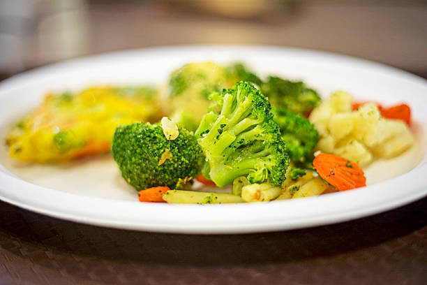 istock Boiled broccoli with vegetables on a disposable plate. Diet and healthy eating 2231201926