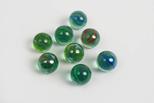 istock Colorful glass marbles scattered on white background 2231202001
