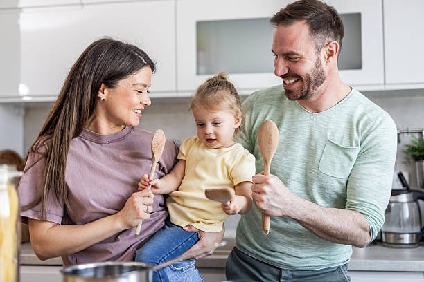 istock Happy family having fun while cooking together in modern kitchen 2231203138