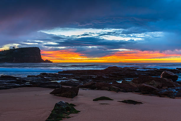 istock Winter sunrise by the sea shore with rain clouds 2231203183