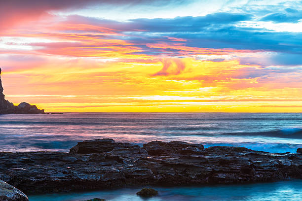 istock Winter sunrise by the sea shore with rain clouds 2231203186