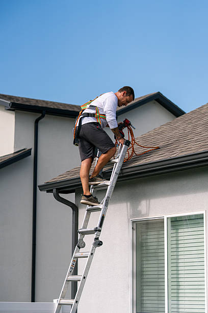 Solar Panel Installation Man Climbing a Ladder to a Rooftop to Inspect, Install, or Remove Solar Panels