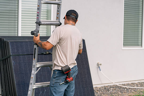 istock Worker with a Solar Panel Installation Company Setting Up a Ladder 2231213634