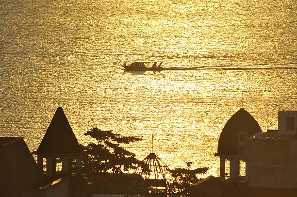 Sunset light with foreground buildings and boats in the sea