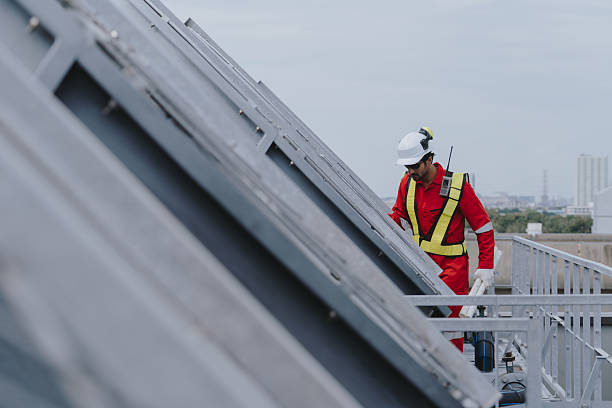 istock Industrial engineers working as a team, maintaining pipes, valves, air conditioning, refrigeration, HVAC systems at construction site. Male technicians in red safety uniforms checking pipe valves. 2231225109