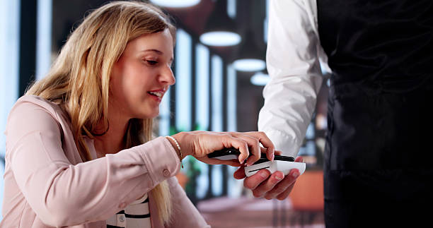 istock Young Woman Makes A NFC Payment 2231230402