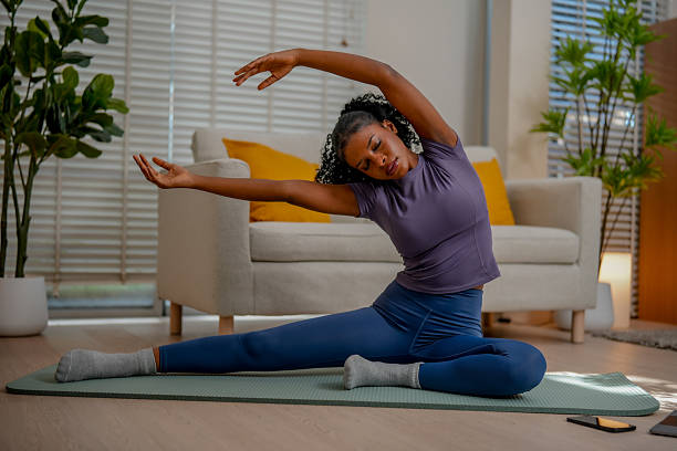 istock Black female engages in indoor exercise, practicing yoga with grace and focus. serene environment enhances her dedication to wellness and mindfulness 2231230640