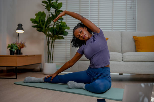 istock Black female engages in indoor exercise, practicing yoga with grace and focus. serene environment enhances her dedication to wellness and mindfulness 2231230646